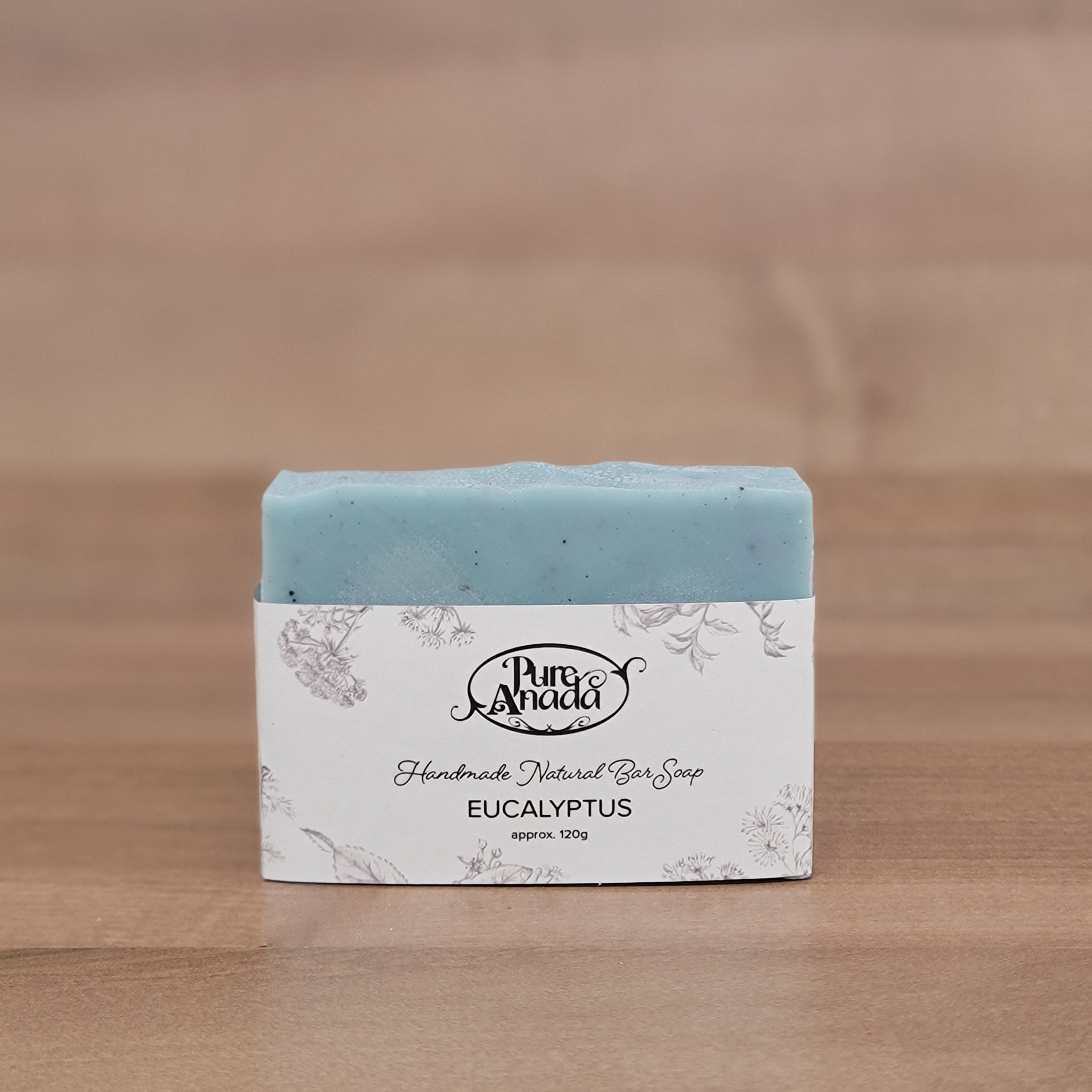 Bar of eucalyptus soap with a label on a wooden surface
